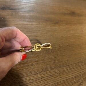 Gold bracelet with the letter F. Faux Fendi